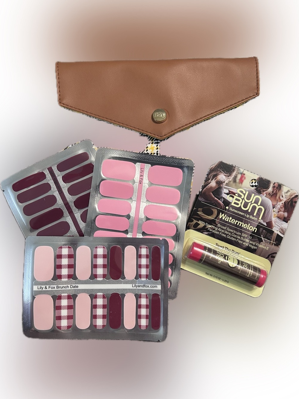 ipsy Brown Clutch with LilyandFox nail strips and Sun Bum